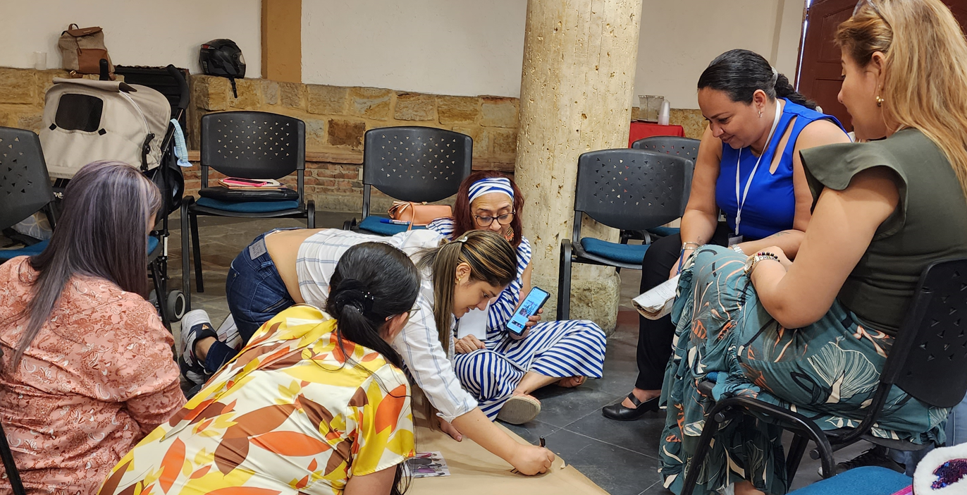 Descripción foto: Representantes de la comunidad y del gobierno municipal de Cúcuta dialogan y elaboran una cartelera en torno a las buenas prácticas y las lecciones aprendidas