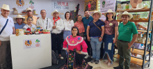 Stand “La Denominación de Origen como herramienta para el desarrollo territorial”. Foto de los asistentes, quienes sonríen a la cámara.